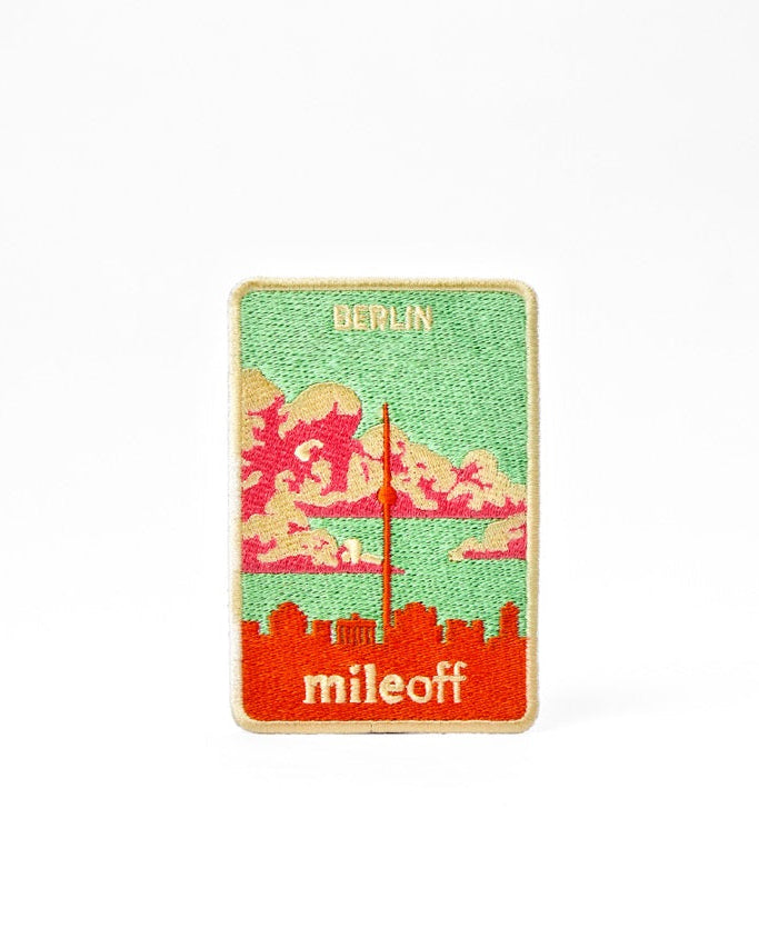 Sticker with a city skyline design and 'mileoff' text on a white background