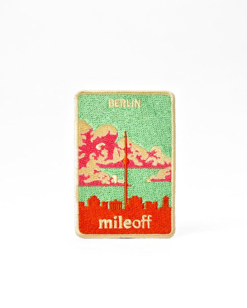 Sticker with a city skyline design and 'mileoff' text on a white background