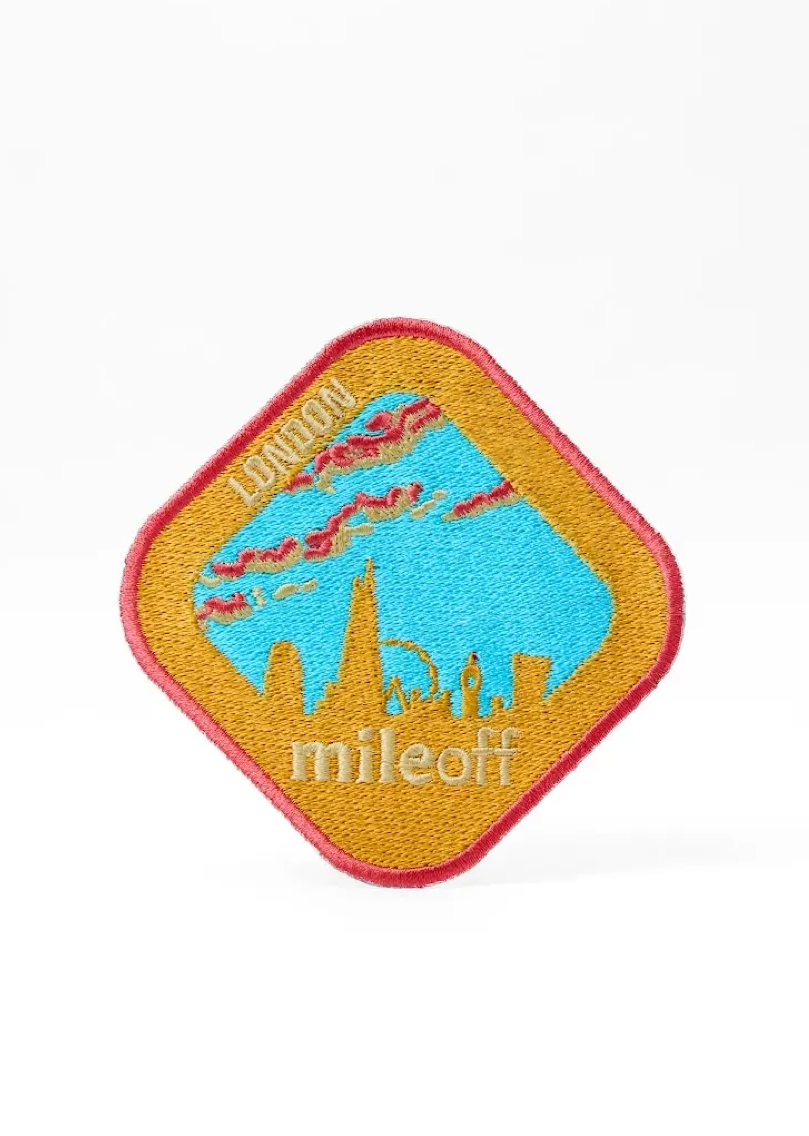 Colorful patch with a design and 'miloffi' text on a white background