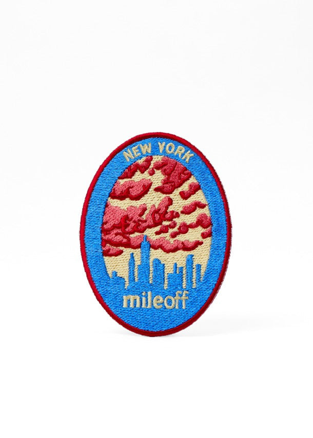 Emblem with New York skyline and 'mileoff' text on a white background