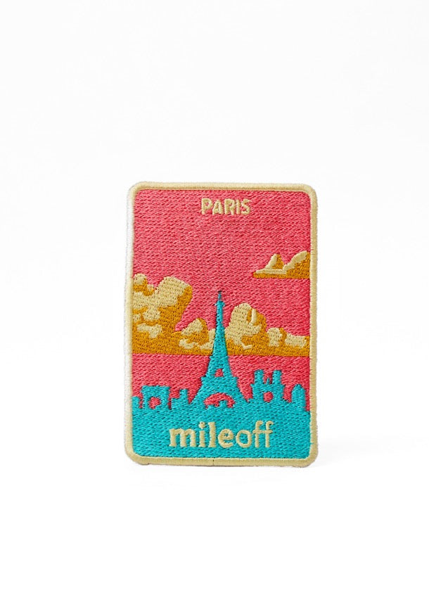 Colorful patch with Eiffel Tower design and 'mileoff' branding on a white background